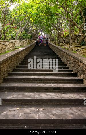 Vertical view of people walking up the steps towards Uluwatu temple in Bali, Indonesia. Stock Photo