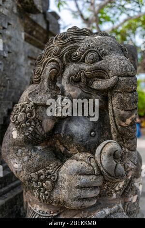 Vertical close up of a traditional gate guardian at Uluwatu temple in Bali, Indonesia. Stock Photo