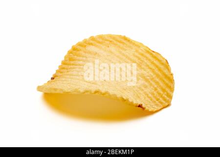 One corrugated or wrinkled potato chip isolated on white background. Close up macro view. Stock Photo