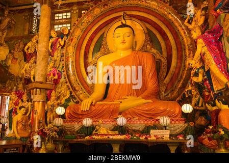 COLOMBO, SRI LANKA - FEBRUARY 22, 2020: Sculpture of a sitting Buddha close-up. Famous Buddhist temple Gangaramaya Temple Stock Photo