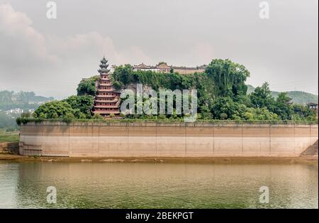 Shibaozhai Temple Pagoda showing the cofferdam protecting it from the rising river level from the three gorges dam, Yangtze River Stock Photo