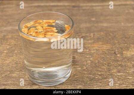 Soaking seeds in water before planting. Wooden Background Stock Photo -  Alamy