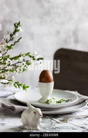 Decorated Easter table with blooming cherry plum. Stock Photo