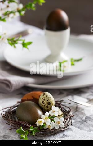 Decorated Easter table with blooming cherry plum. Stock Photo
