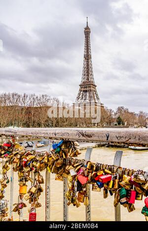 Love padlocks on the Debilly footbridge over the River Seine, with the Eiffel Tower behind. Paris, France. February 2020. Stock Photo