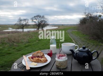 Breakfast outside one of the shepherd's huts at Elmley Nature Reserve on the Isle of Sheppey, Kent Stock Photo
