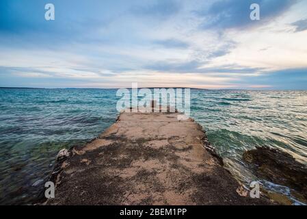 sunset on croatian stony beach Stock Photo
