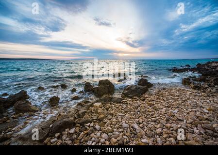sunset on croatian stony beach Stock Photo