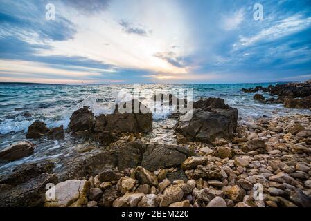 sunset on croatian stony beach Stock Photo