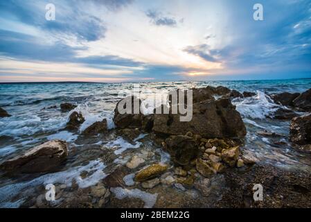 sunset on croatian stony beach Stock Photo