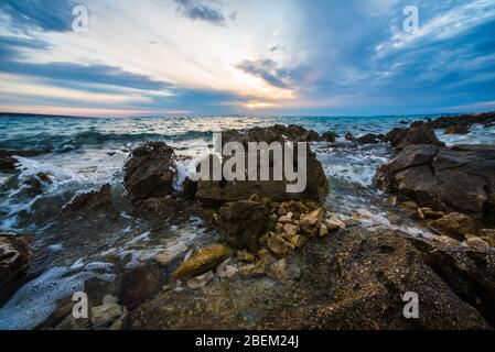 sunset on croatian stony beach Stock Photo