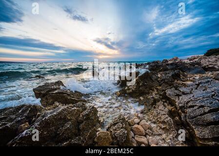 sunset on croatian stony beach Stock Photo - Alamy