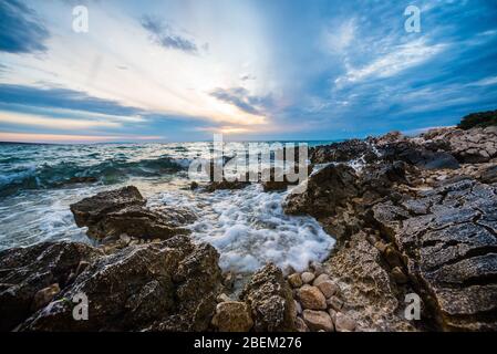 sunset on croatian stony beach Stock Photo - Alamy