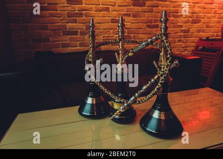 Stylish wooden hookah in the evening on a summer terrace in a cafe Stock Photo