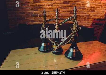 Stylish wooden hookah in the evening on a summer terrace in a cafe Stock Photo
