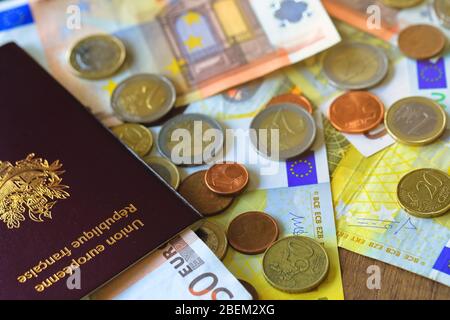Close up of Euro money banknotes and travelling passport on table Stock Photo
