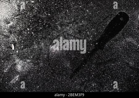 Traces of tools on a black table dusted with white dust Stock Photo - Alamy
