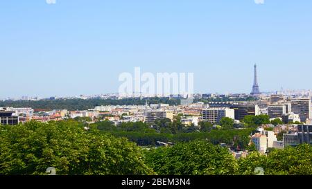 Paris, France - August 26, 2019: Paris from above showcasing the capital city's rooftops, the Eiffel Tower, Paris tree-lined avenues with their