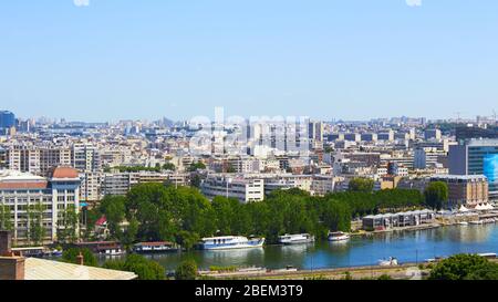 Paris, France - August 26, 2019: Paris from above showcasing the capital city's rooftops, the Eiffel Tower, Paris tree-lined avenues with their