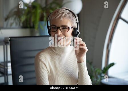 Smiling businesswoman consult client online on laptop Stock Photo