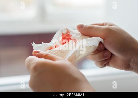 Photo of hands holding a napkin with blood Stock Photo