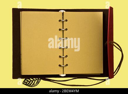 Top view image of open notebook with blank pages isolated on a yellow background, ready for adding text or mockup Stock Photo