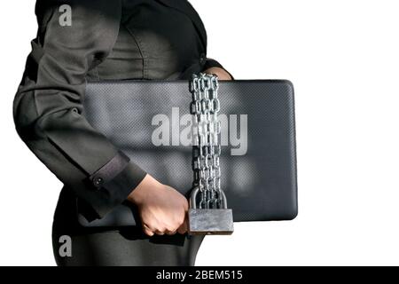 Laptop wrapped in a chain in the hands of a woman isolated on white background, computer security theme Stock Photo