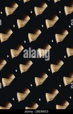 Pattern. Gold toilet paper with a crown on a black background. A concept on the topic of coronavirus and pandemic. Stock Photo