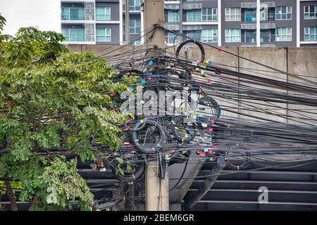 Chaos or order of cables and wires on an electric pole like a sky spaghetti Stock Photo