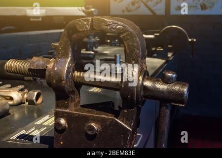 Old metal vise on the table tool Stock Photo