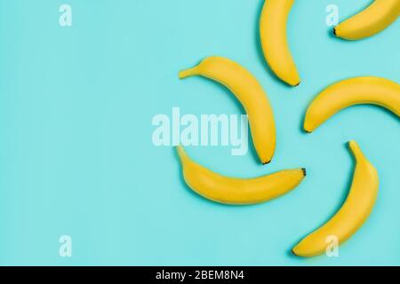 Flat lay of bananas on blue background with copy space Stock Photo