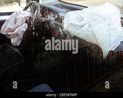 Both airbags deployed in a hit and run accident.  Interior of a automobile involved in a front crash with a deployed steering column airbag. Stock Photo