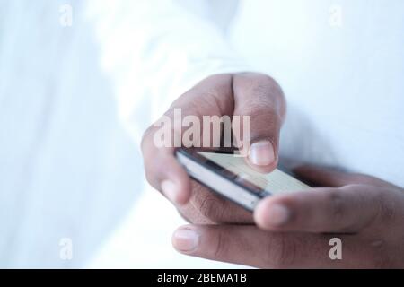 Close up of a young man using mobile smart phone Stock Photo