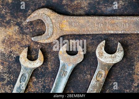 Vintage rusty carpentry tools, different size wrenches on grunge background, repair concept, top view Stock Photo