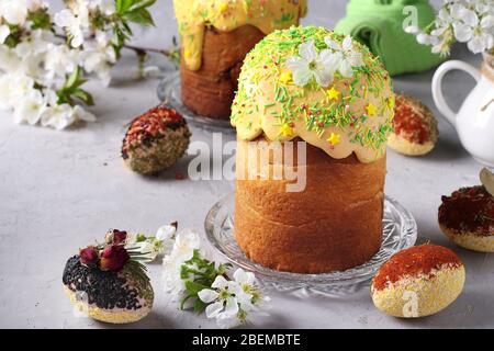 Easter cakes with colored glaze and decoration sprinkling and Easter eggs decorated with spices and cereals, Closeup Stock Photo