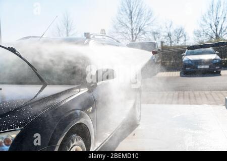 washing program at the self-service station. washing, rinsing and polishing of the car body under high pressure using treated water Stock Photo