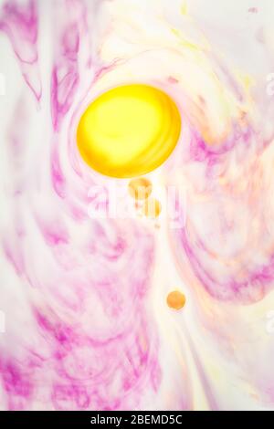 Flowing yellow bubble in pink ink Stock Photo