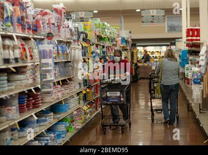 Doylestown, United States. 14th Apr, 2020. Freddy Acosta (left) shops in an aisle as employees and customers follow safety protocol to help avoid coronavirus Tuesday, April 14, 2020 at ACME Market in Doylestown, Pennsylvania. Credit: William Thomas Cain/Alamy Live News Stock Photo