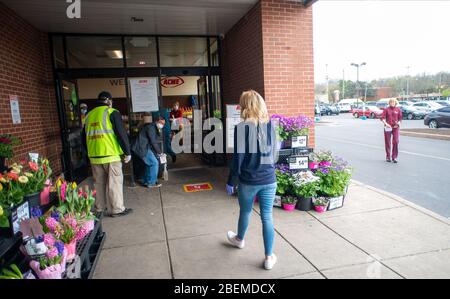 Doylestown, United States. 14th Apr, 2020. A woman waits to enter the store as employees and customers follow safety protocols to help avoid coronavirus Tuesday, April 14, 2020 at ACME Market in Doylestown, Pennsylvania. Credit: William Thomas Cain/Alamy Live News Stock Photo