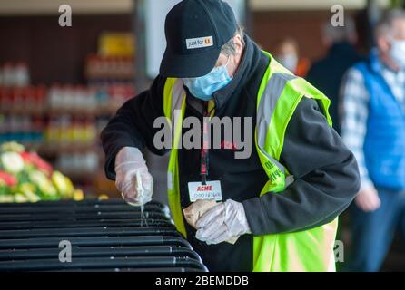 Doylestown, United States. 14th Apr, 2020. Employee Tom Guy sanitizes carts as employees and customers follow safety protocols to help avoid coronavirus Tuesday, April 14, 2020 at ACME Market in Doylestown, Pennsylvania. Credit: William Thomas Cain/Alamy Live News Stock Photo