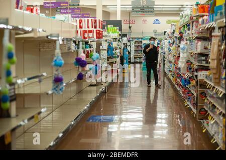 Doylestown, United States. 14th Apr, 2020. A man walks down an aisle while shopping as employees and customers follow safety protocols to help avoid coronavirus Tuesday, April 14, 2020 at ACME Market in Doylestown, Pennsylvania. Credit: William Thomas Cain/Alamy Live News Stock Photo