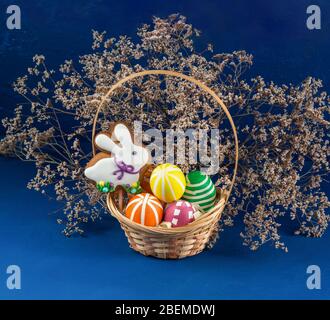 Easter Bunny and colorful eggs on a blue background. Spring chrestian holiday Stock Photo