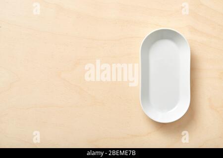 Top view of empty white food plate on a wood background. Stock Photo