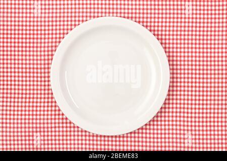 White empty plate on red checked tablecloth Stock Photo