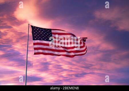 An american flag waving in the sunset Stock Photo