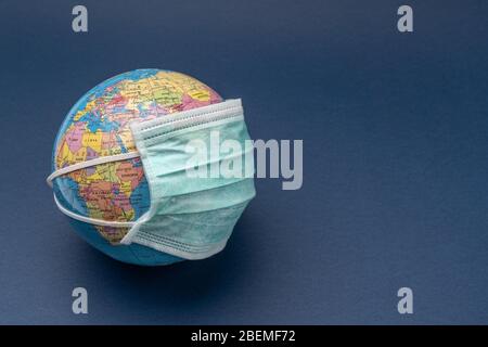 On the globe wearing a medical mask from coronavirus and allergies. Stock Photo