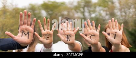Word merci written on child hands, panoramic view Stock Photo