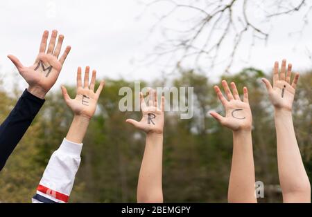 Word merci written on child hands outdoor Stock Photo