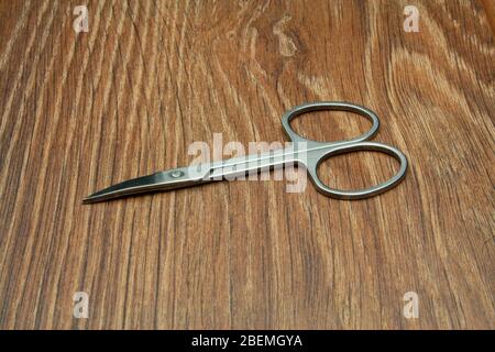 Close-up manicure scissors isolated on wooden background Stock Photo