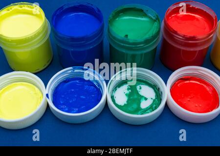 Close up of open multicolored acrylic paint cans Stock Photo